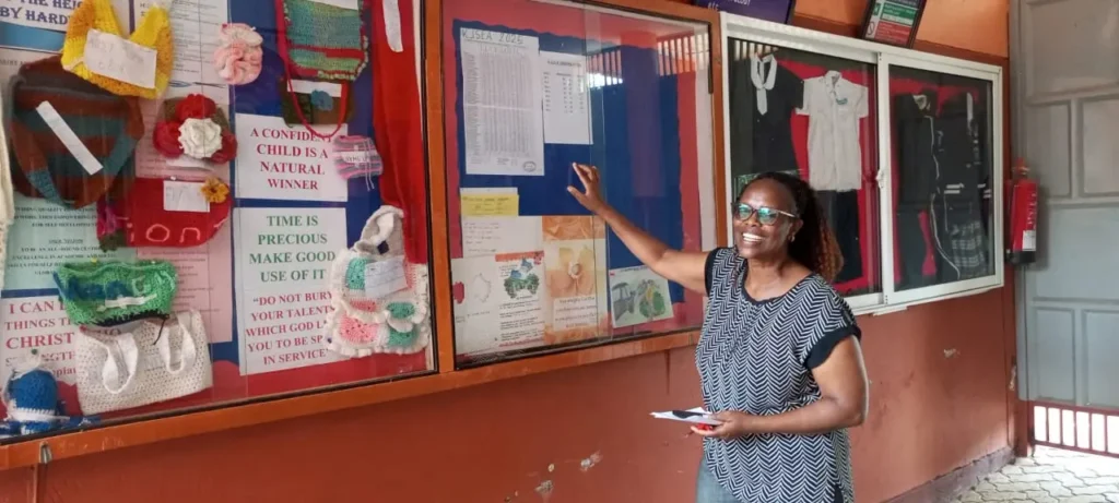 Esther Mihingu st. Anthony's school kindergarten primary and junior school kiambu headteacher going through the performance list of KJSEA results
